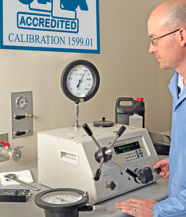 Operator Setting Pressure on an Electronic Deadweight Tester to the Exact Nominal Value on the Guage Under Test